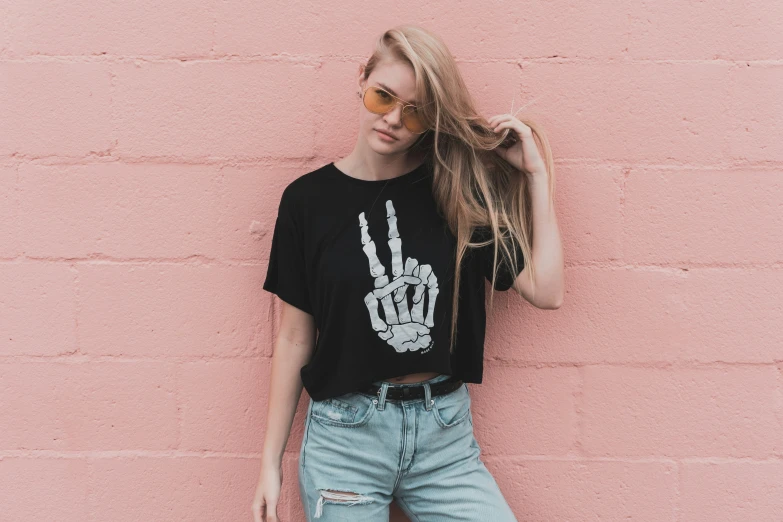 a woman posing with her hair styled into a skeleton hand