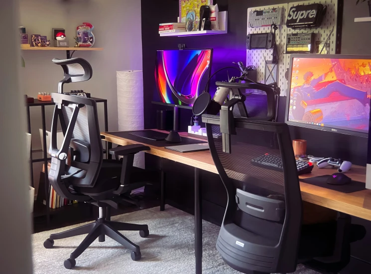 the computer desk has two monitors on it