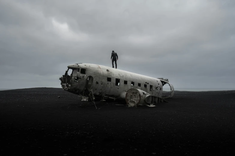 an airplane is sitting on some black dirt