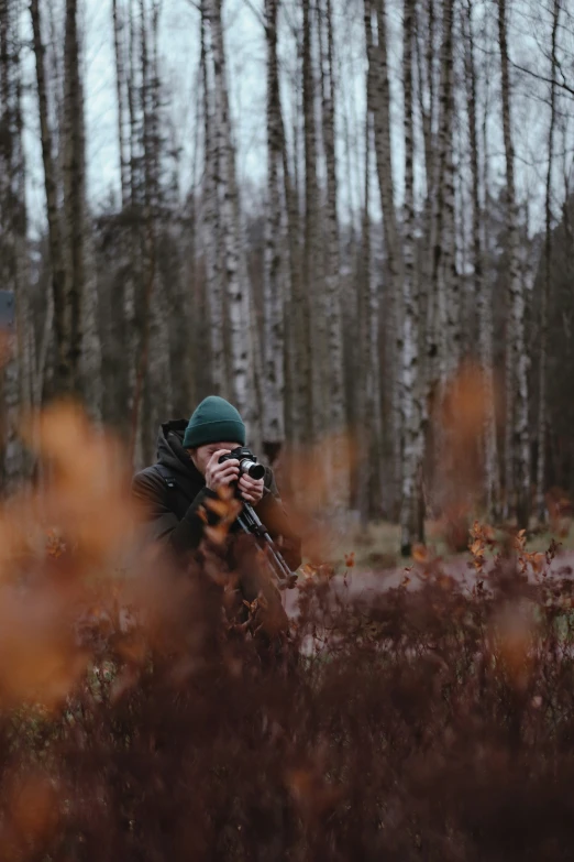 the person is taking pictures in the woods