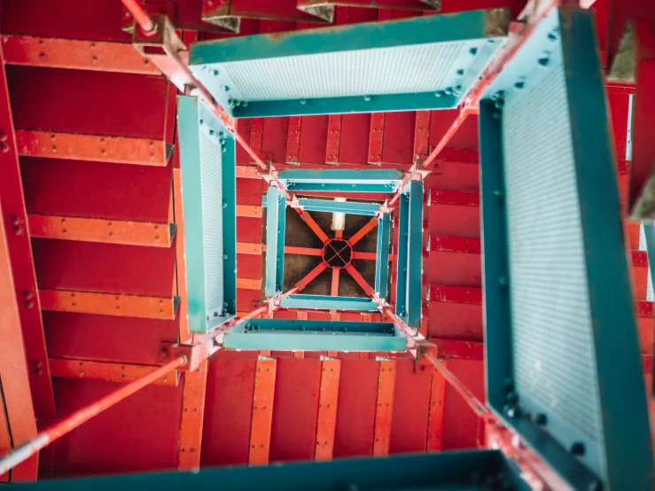 the view from underneath of a red and green structure