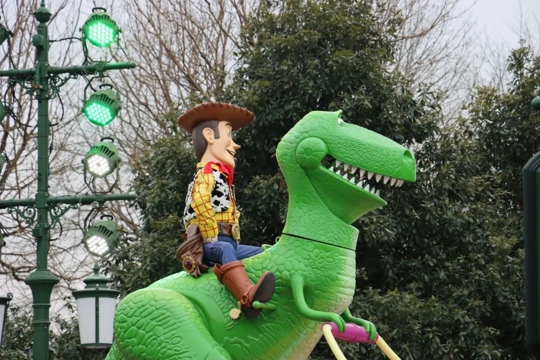 a dinosaur statue with a cowboy hat and suit