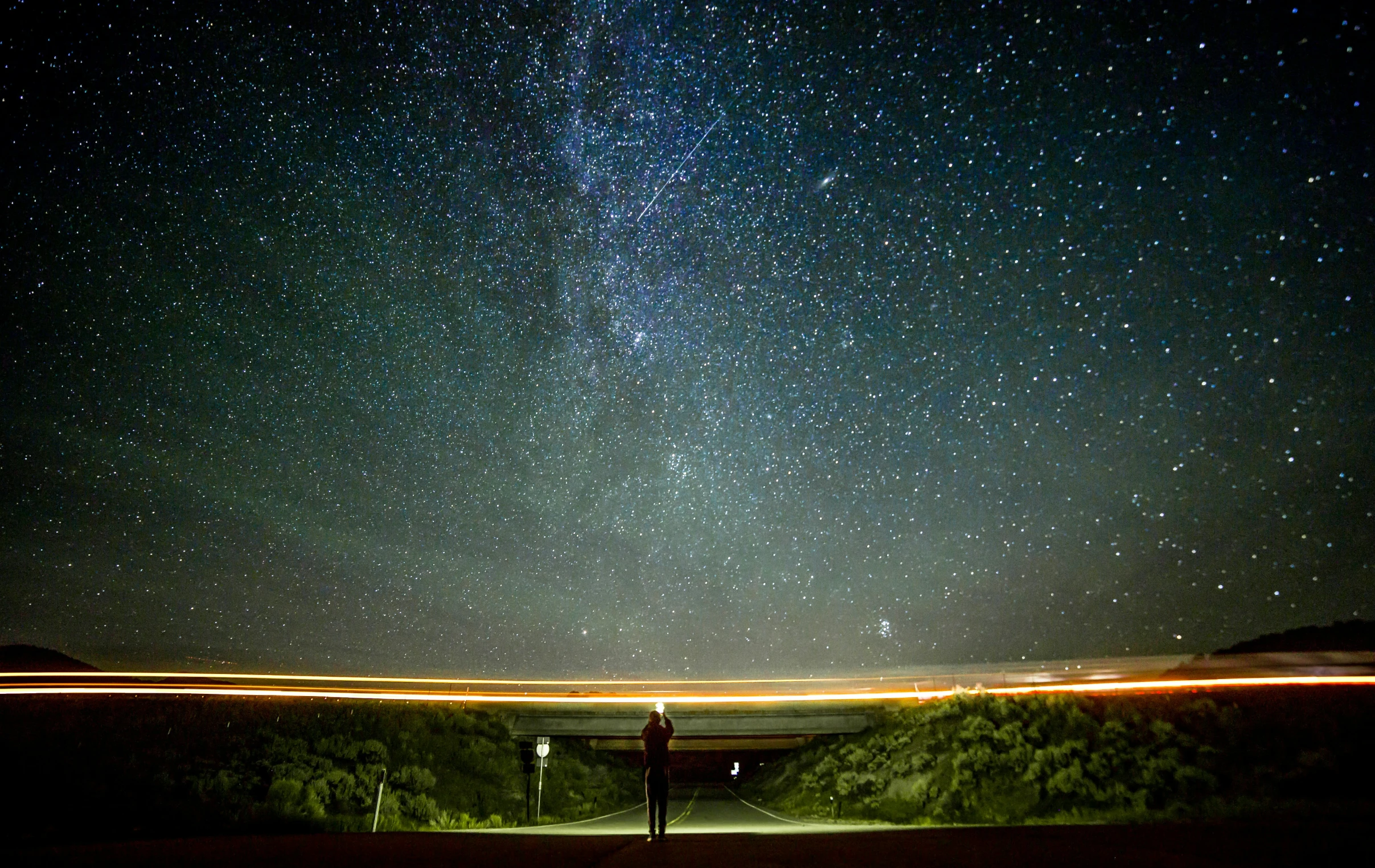 a street light at night under the stars