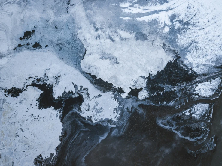 a sea of white snow and ice near water