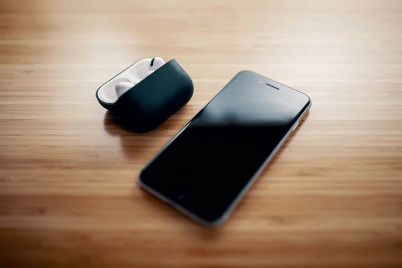 a black cellphone next to an iphone