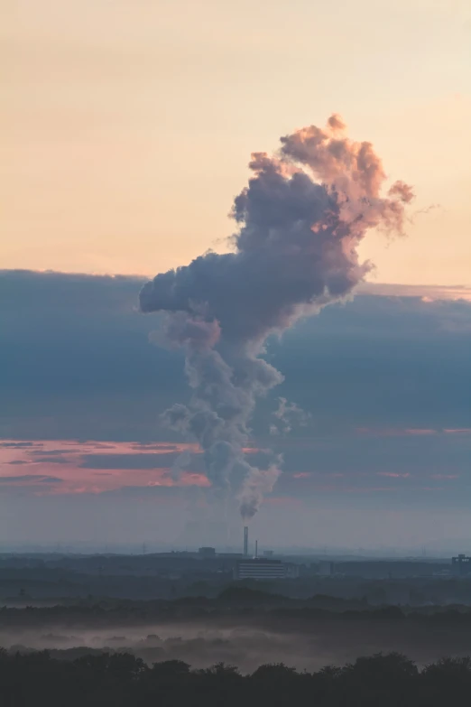 an industrial pipe in the distance with a cloudy sky