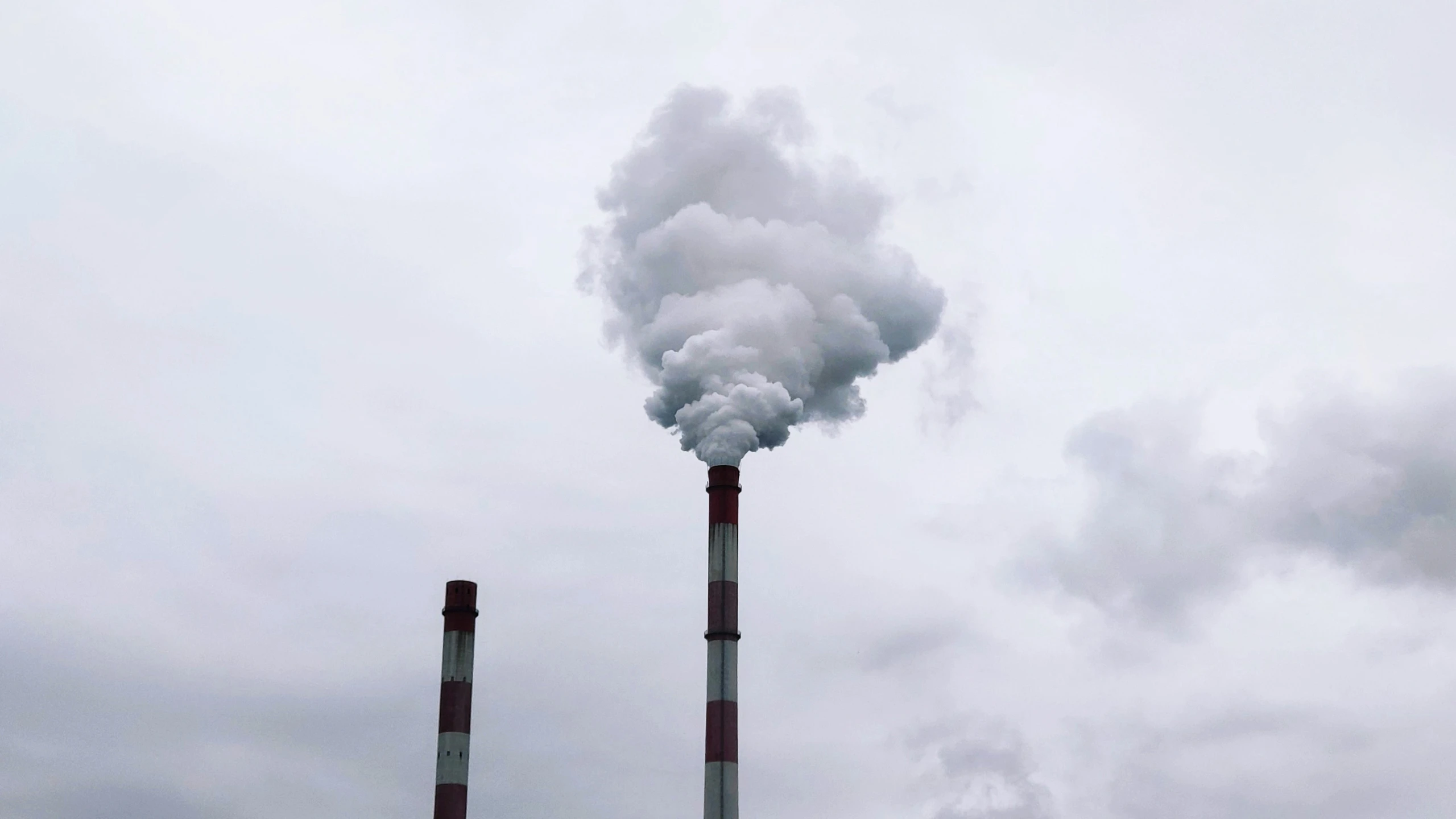 smoke billows out from two stacks of steel