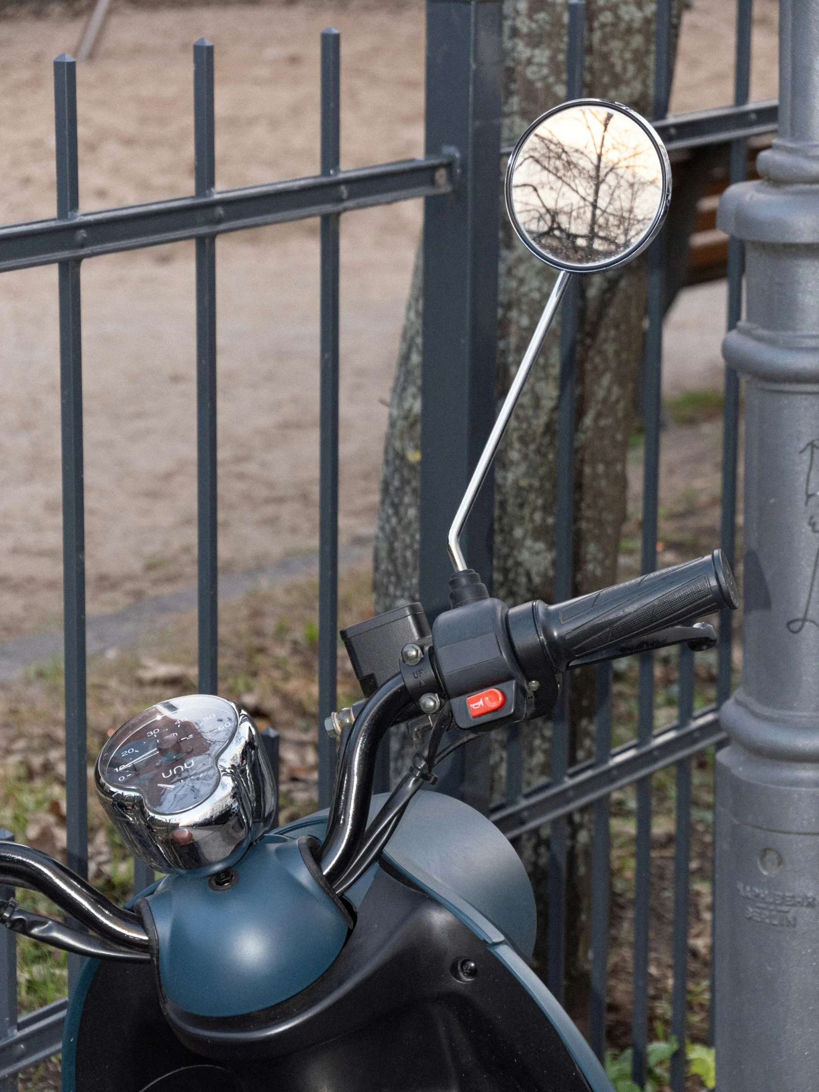 a black motor scooter with a mirror and seat