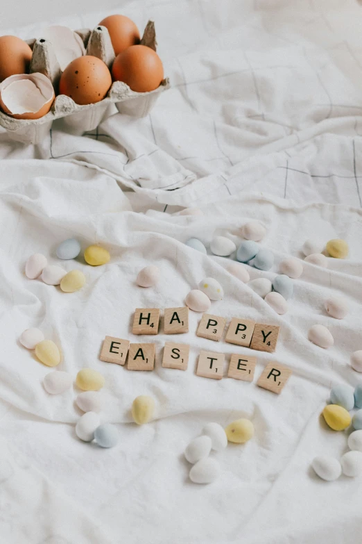 several wooden scrabbles laying on a table with egg and eggs