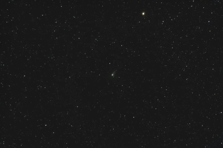 stars on the night sky and one small white dot visible