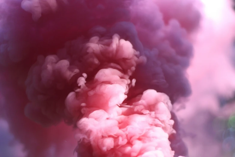 smoke comes out of a black pipe with pink smoke