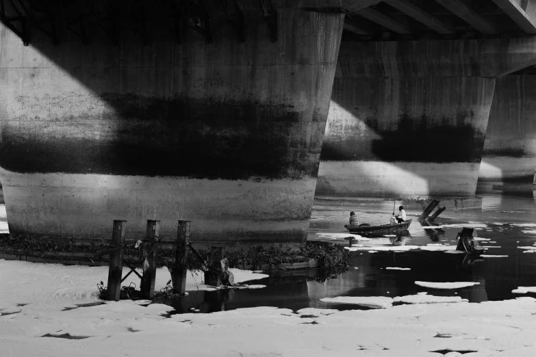 a large bridge is shown from the shore and some water