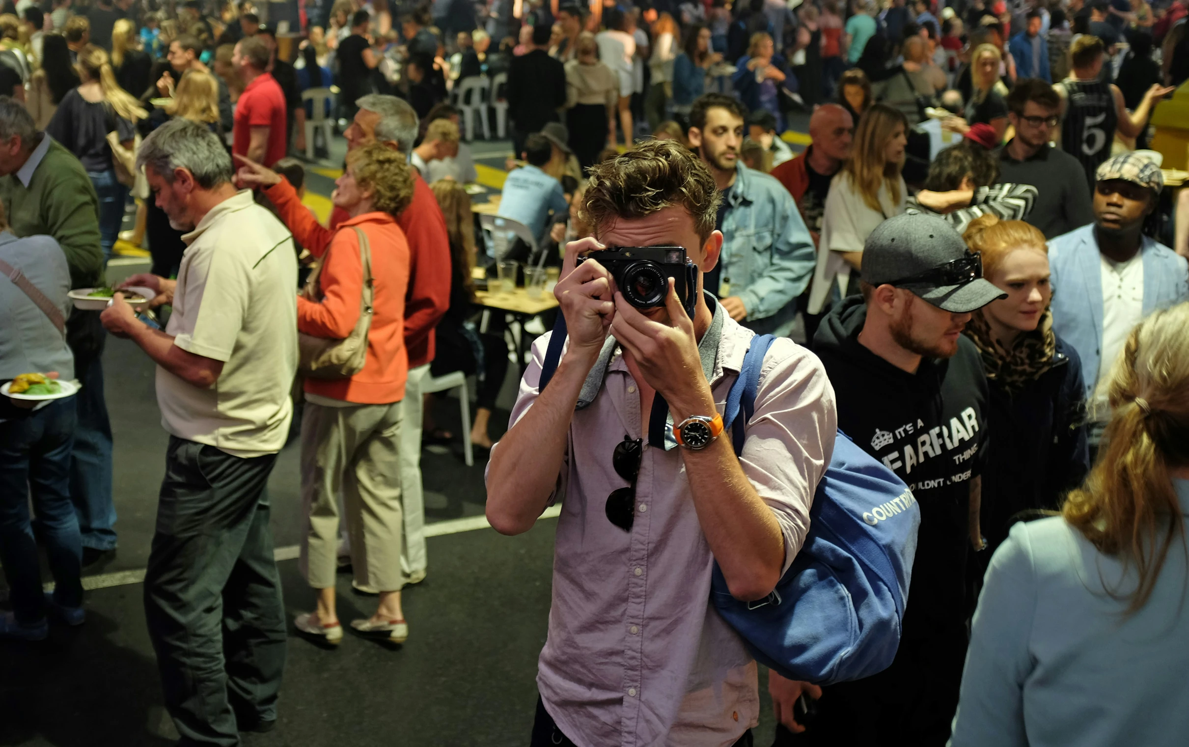 a group of people standing around each other taking pictures