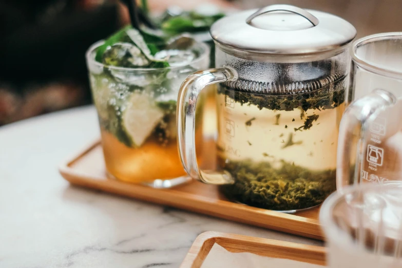 tea in glasses sitting on tray with tray of drinks