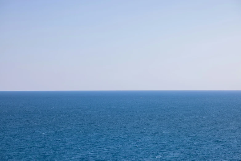 the boat is sailing out to sea on a sunny day