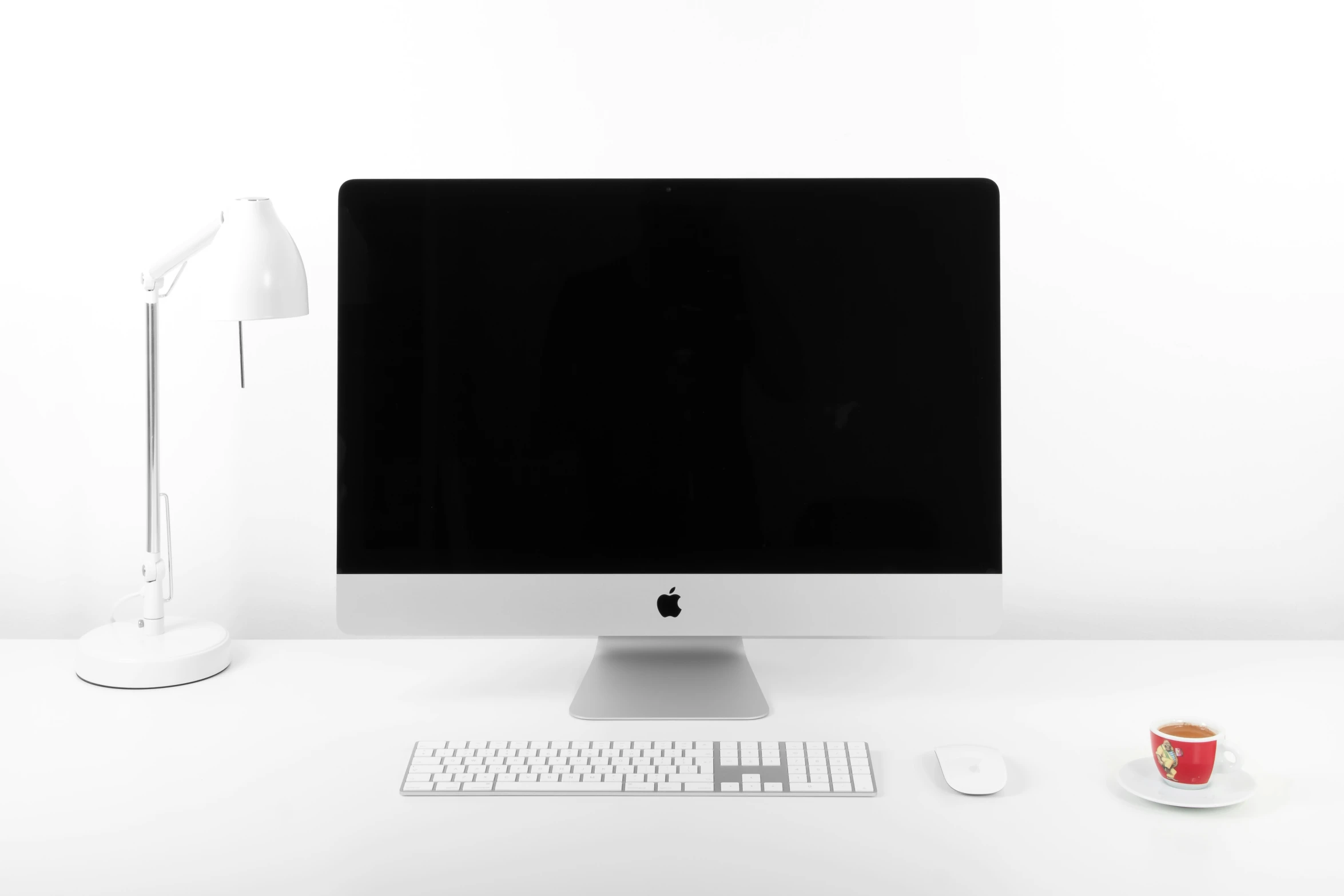 a computer monitor is on a white desk