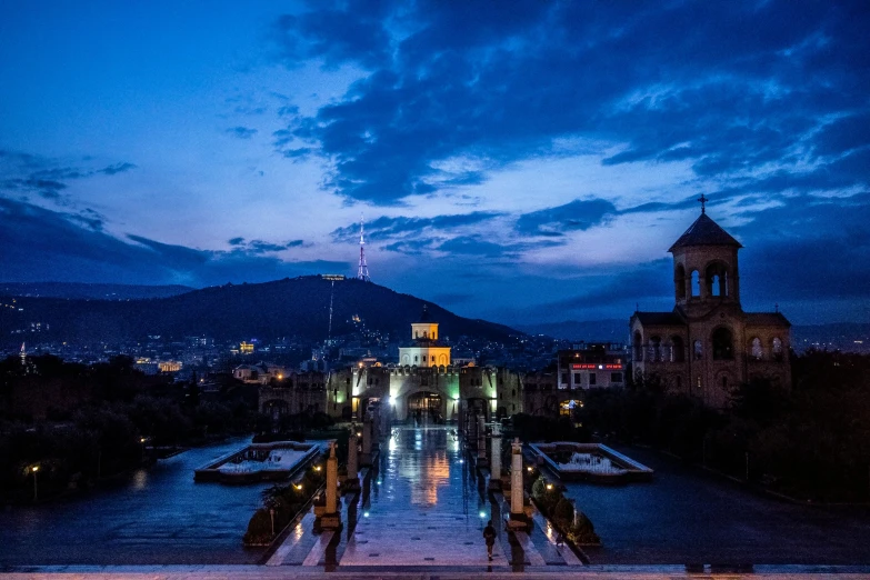 this is an image of a city with some buildings and water at night