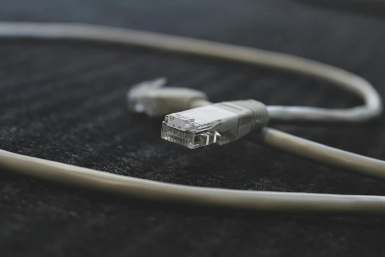 an electrical cord is being plugged in the cord of an electric device