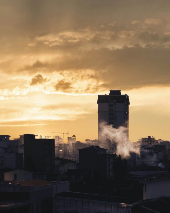 a city skyline with smoke coming out of the buildings