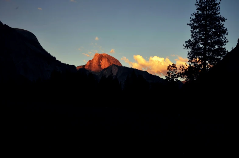 mountains with trees near them at night time