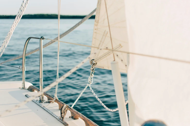 a sailboat out in the ocean with its roped sails down