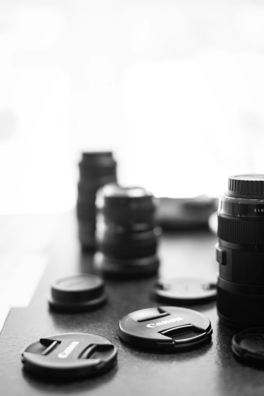 two cameras are lying on a table and some other items