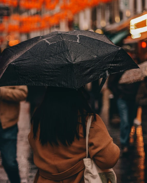 there is a woman holding an umbrella in the rain