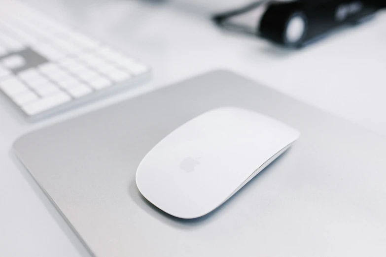 a white mouse and keyboard on a desk