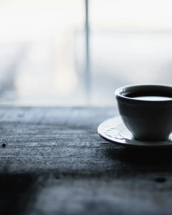 a cup of coffee sits on a saucer