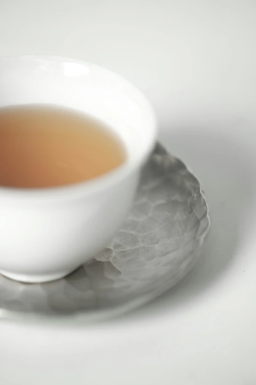 a tea cup is on a white saucer