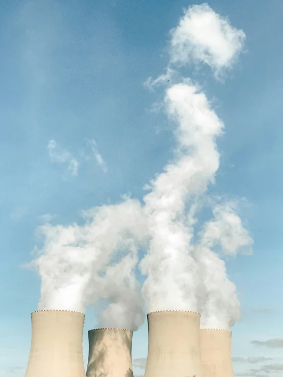 a po of a very big cooling plant with some smoke coming out