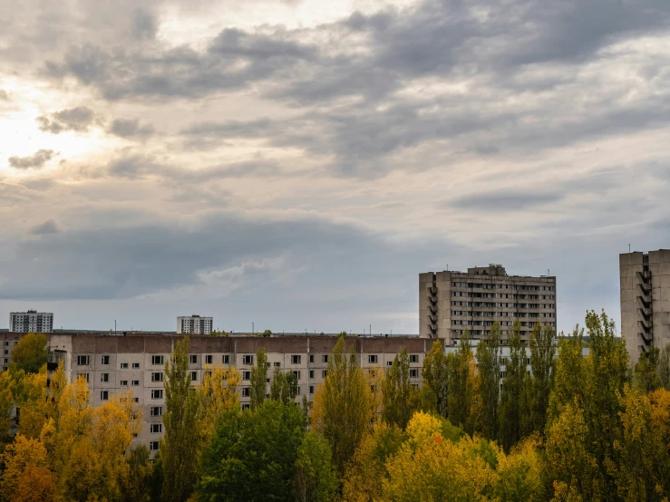 several high rise buildings are shown under cloudy skies