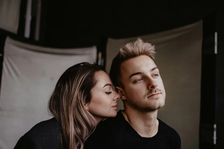 a young man and woman stare at the camera