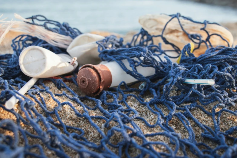 an assortment of sea debris and fishing floats lie on the sand