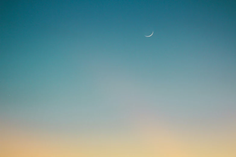 an airplane flies through the sky with two people in the distance