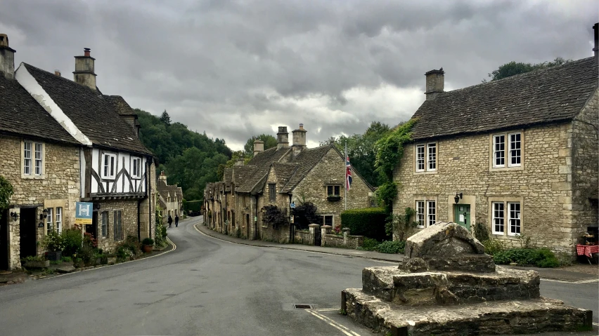 a quiet street between two stone cottages