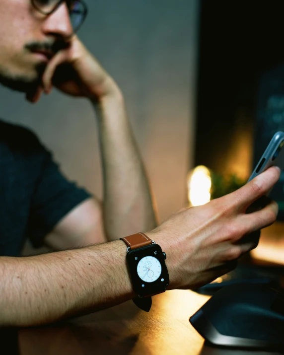 a man with a watch and cellphone on his wrist