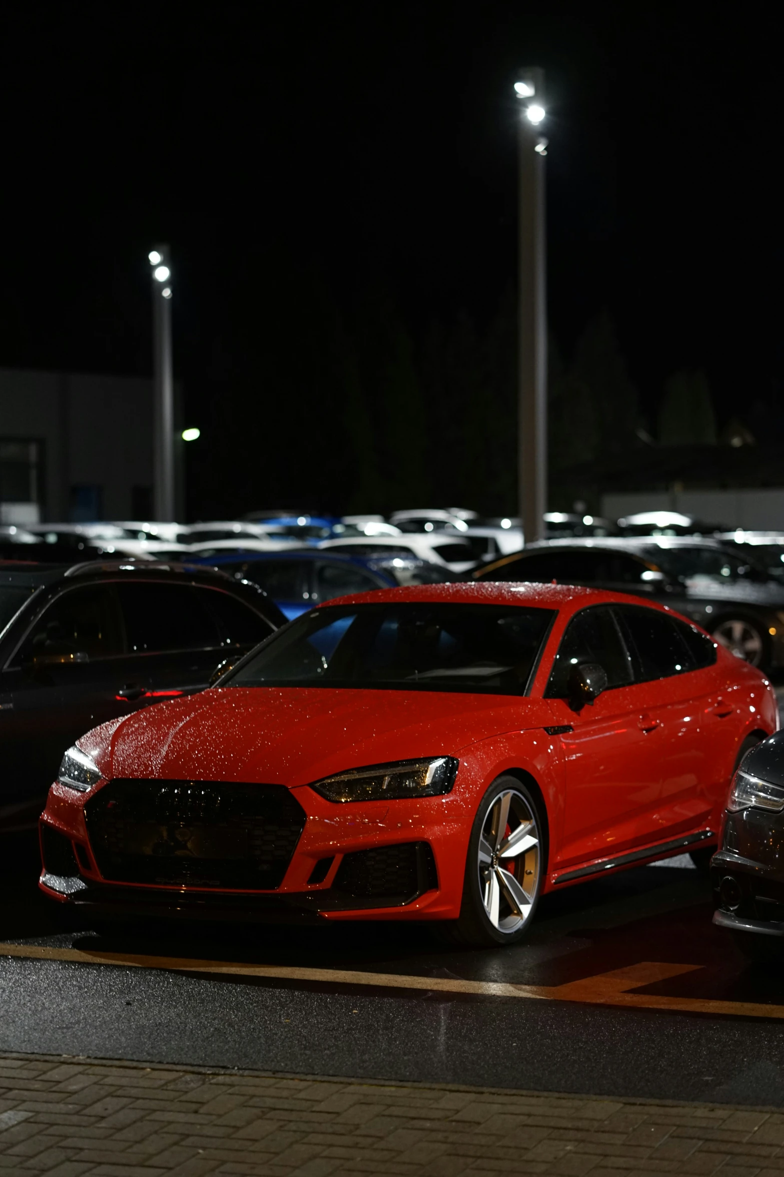 a red sports car parked in a parking lot