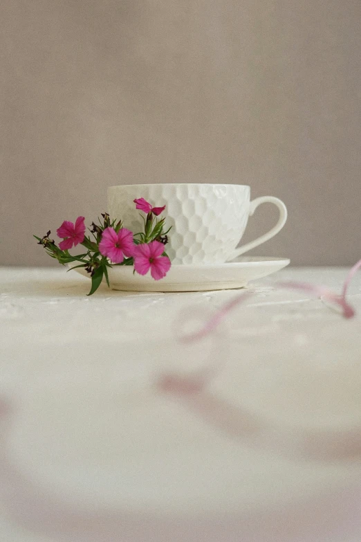 a close up of a flower in a cup