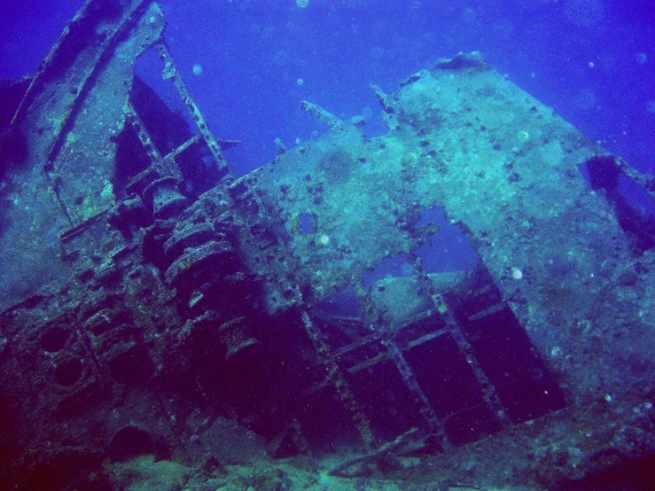 a ship wreck sitting under the water with stairs coming out