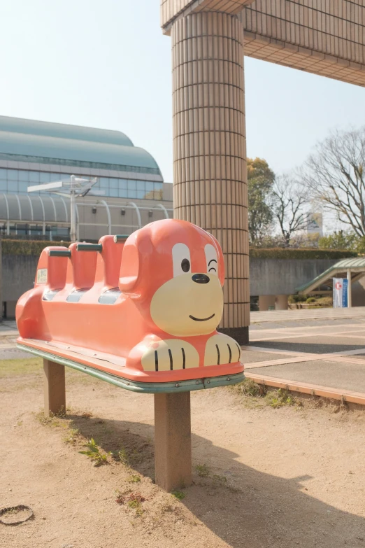 the park bench with a train in it in front of a building