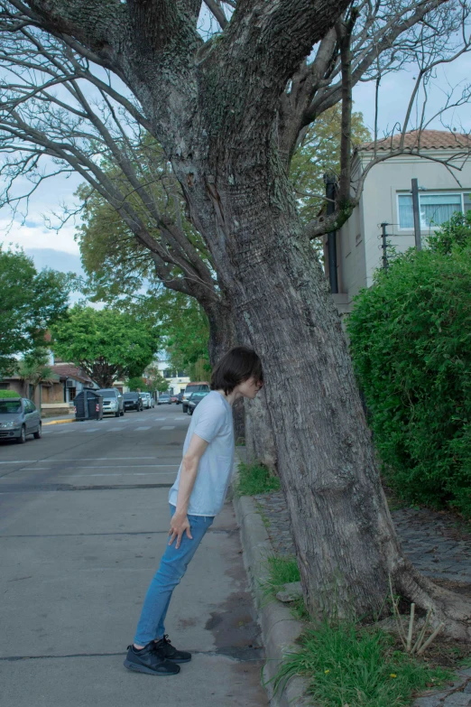a person leaning against the tree with their foot in the trunk