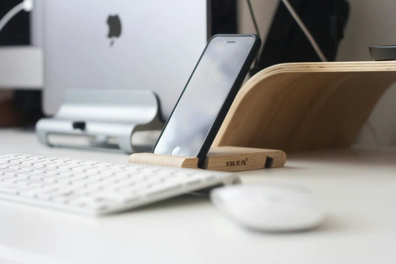 a cell phone in an ipad and tablet holder attached to a dock