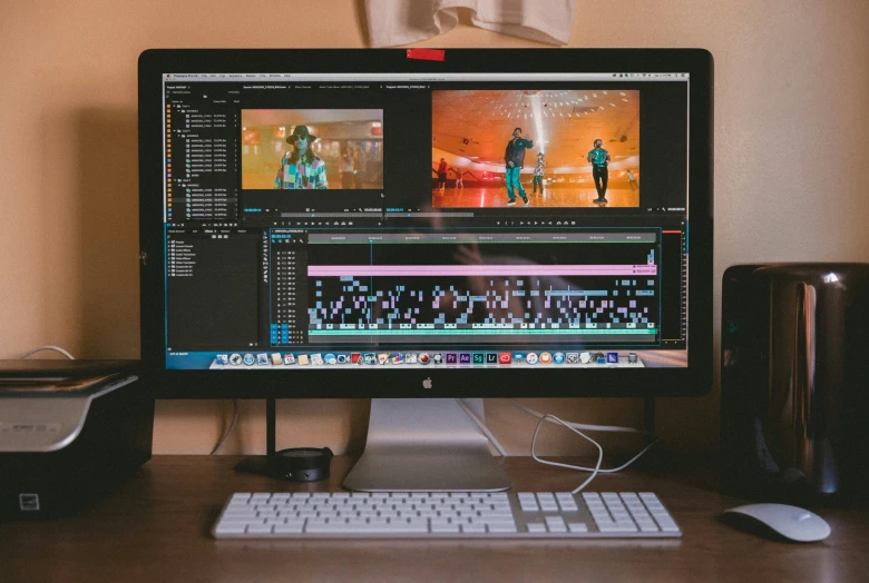 the computer monitor and keyboard are on the desk