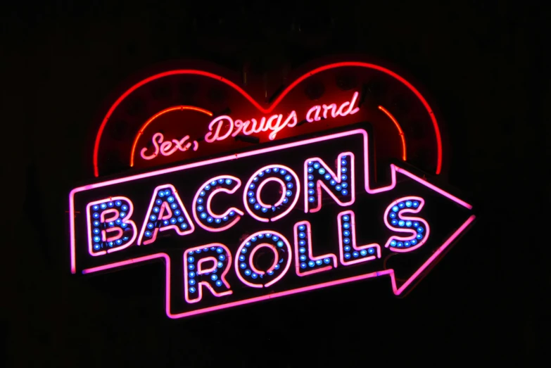 a neon sign that says sex  and bacon rolls