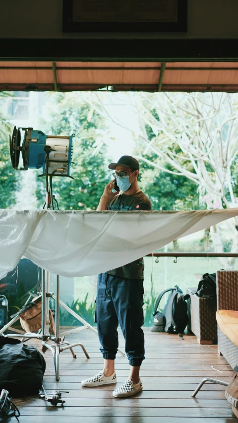 a man is wearing a face mask while standing on a stage