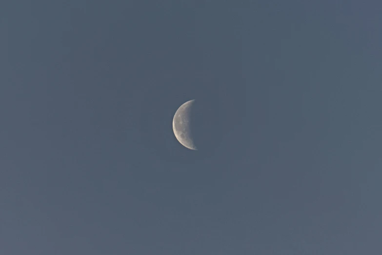 a half - moon shines bright in the sky