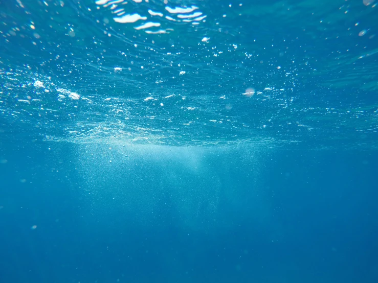 blue ocean surface showing deep water and bubbles