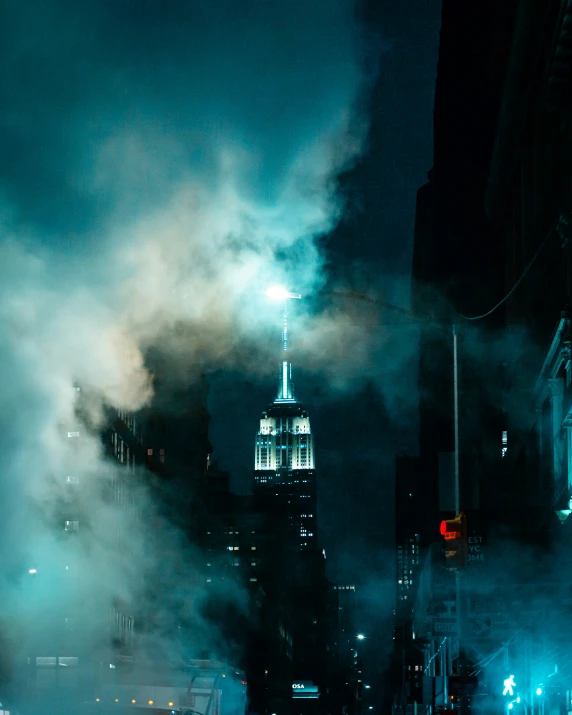 the empire building is lit up on an overcast night