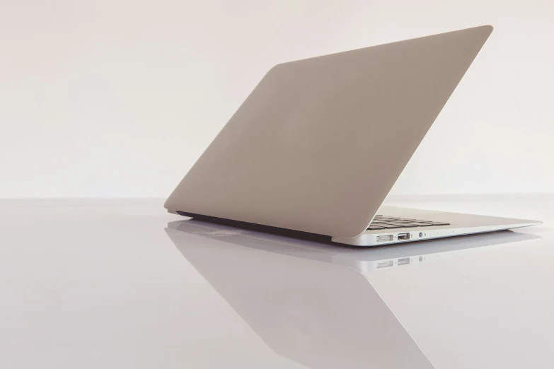 an open macbook air laptop computer sitting on a table